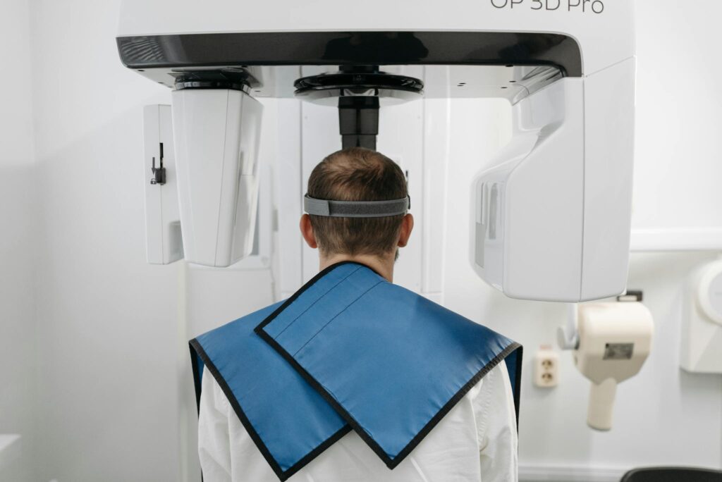 Man undergoing a panoramic radiograph with modern dental technology in a clinic.